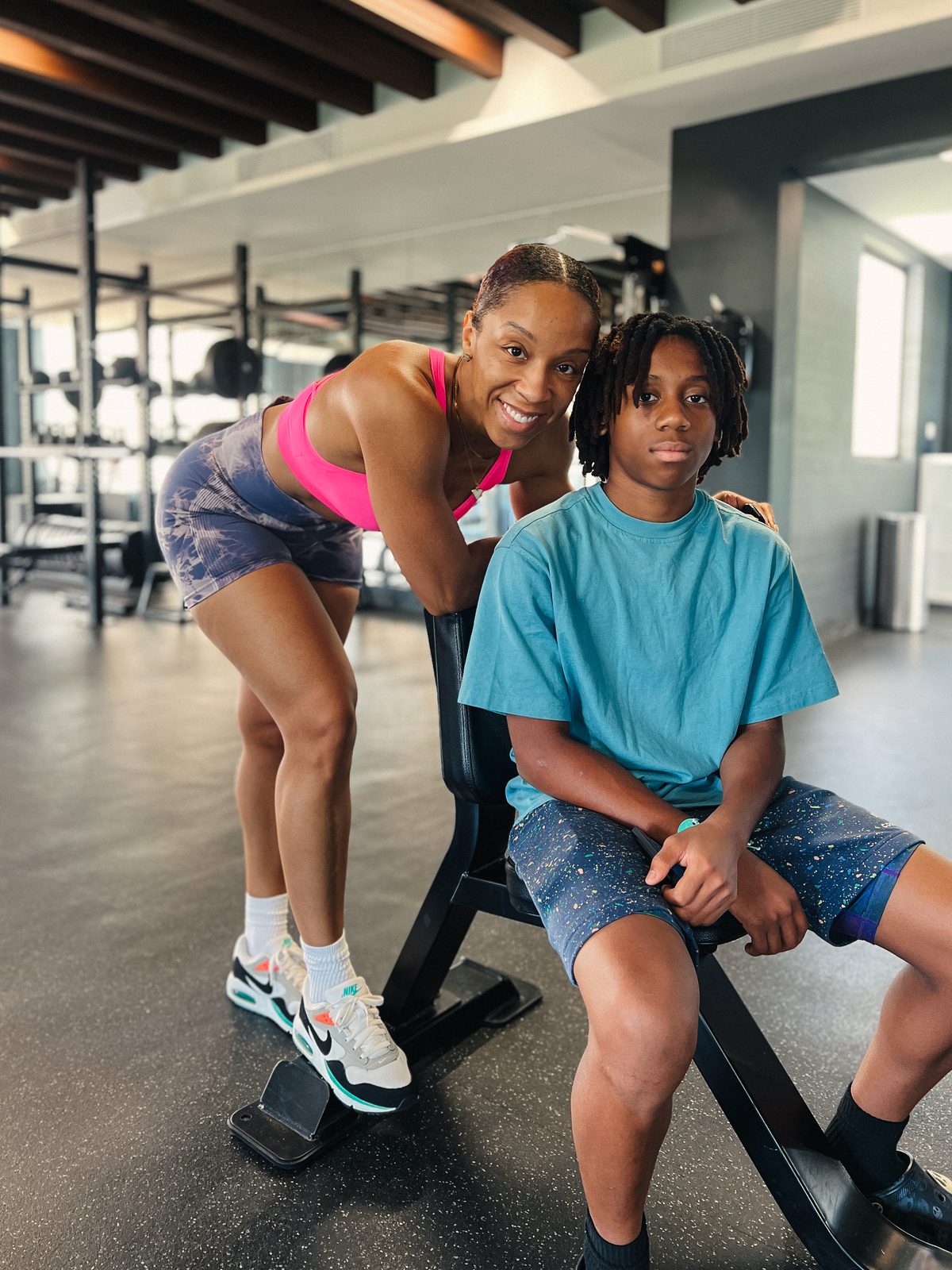 Parent and child working out together at the gym